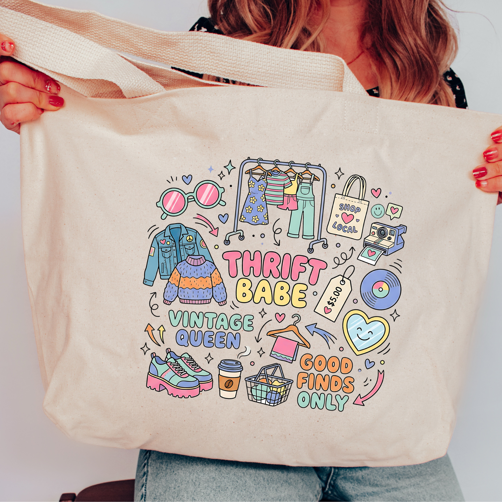 Person holding a tote bag with 'Thrift Babe Vintage Queen Good Finds Only' design.